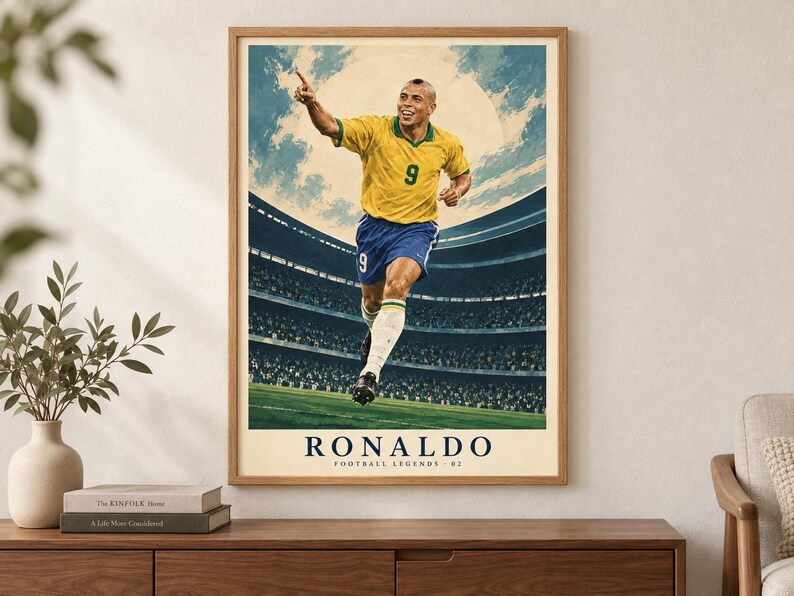 May include: A framed vertical poster featuring a stylized illustration of a soccer player wearing a yellow jersey with the number 9 and blue shorts, running on a field inside a stadium. The text RONALDO FOOTBALL LEGENDS 02 is printed at the bottom.