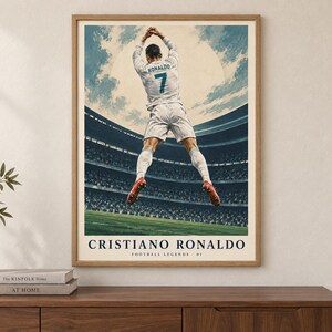 May include: A framed poster featuring a soccer player in a white uniform with the name RONALDO and number 7 on the back, jumping in a stadium. The text CRISTIANO RONALDO and FOOTBALL LEGENDS 01 is printed at the bottom of the illustration.