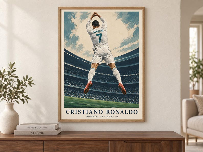 May include: A framed poster featuring a soccer player in a white uniform with the name RONALDO and number 7 on the back, jumping in a stadium. The text CRISTIANO RONALDO and FOOTBALL LEGENDS 01 is printed at the bottom of the illustration.
