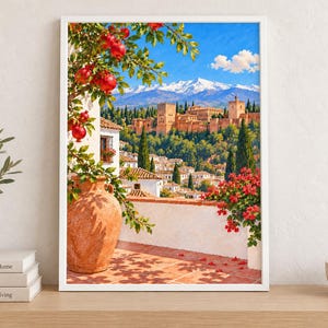 May include: A framed wall art print depicting a Mediterranean scene with a large terracotta vase, a pomegranate tree, and a white stone terrace overlooking a historic fortress complex with snow-capped mountains under a bright blue sky.