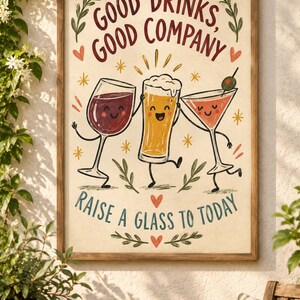 May include: A framed wall art print featuring a cartoon illustration of a wine glass, a beer glass, and a martini glass with faces. The text reads Good Drinks, Good Company and Raise A Glass To Today, accented with small red hearts and yellow stars.