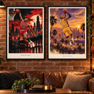 May include: Two framed wall art prints featuring basketball players. The left print shows Michael Jordan in a red Chicago Bulls jersey dunking against a red city skyline. The right print shows Kobe Bryant in a yellow jersey jumping against a sunset.