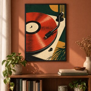 May include: A framed wall art print featuring a stylized illustration of a red vinyl record on a turntable. The composition includes geometric shapes in dark green, cream, and yellow, with a black tonearm resting on the record surface.