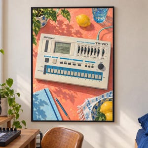 May include: A framed wall art print featuring a Roland TR-727 Rhythm Composer drum machine on a coral-coloured surface. The illustration includes a lemon, a blue glass of water, a blue notebook, a pencil, and a bowl of lemons, all under sunlight.