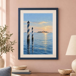 May include: A framed wall art print depicting a serene seascape with two blue and white striped wooden mooring poles in the foreground. The background features a distant island with buildings under a soft sunrise sky reflecting on the water.
