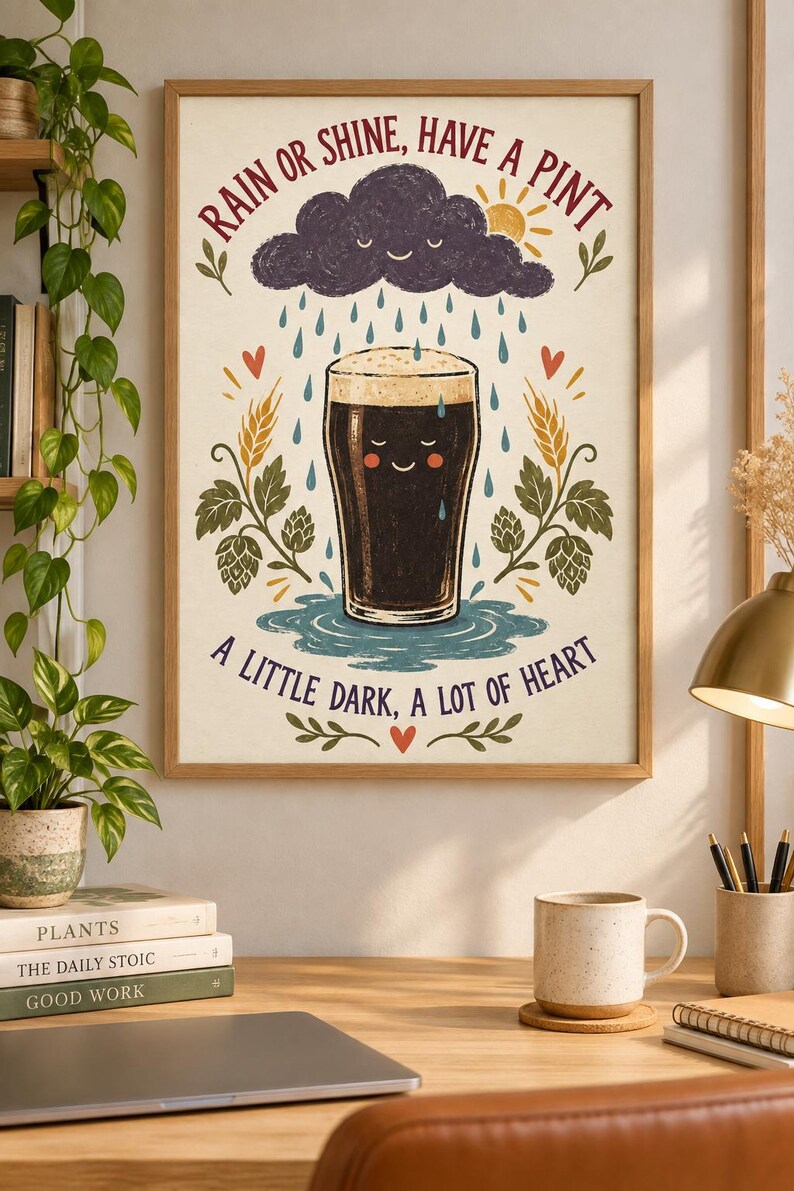 May include: A framed wall art print featuring a dark beer pint with a smiling face, surrounded by rain, a sun, and hop plants. The text reads: RAIN OR SHINE, HAVE A PINT and A LITTLE DARK, A LOT OF HEART, with red hearts and green foliage accents.