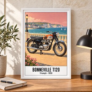 May include: A framed wall art print featuring a vintage orange and silver Triumph Bonneville T120 motorcycle parked on a coastal promenade. The text at the bottom reads BONNEVILLE T120 Triumph 1959. The background shows a seaside town and cliffs.