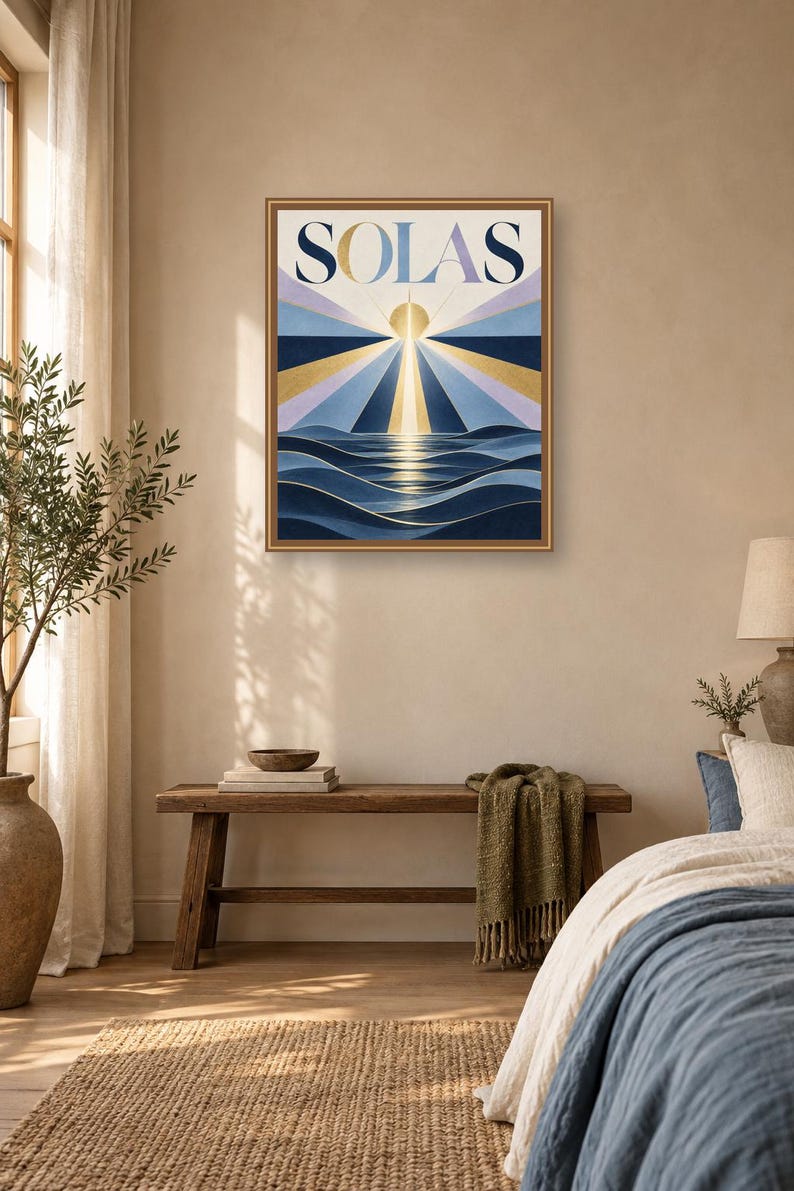 May include: A rectangular wall art print in a thin brown frame featuring the word SOLAS in large dark blue letters. The artwork depicts a stylized golden sun rising over dark blue ocean waves with radiating beams of light in shades of blue.