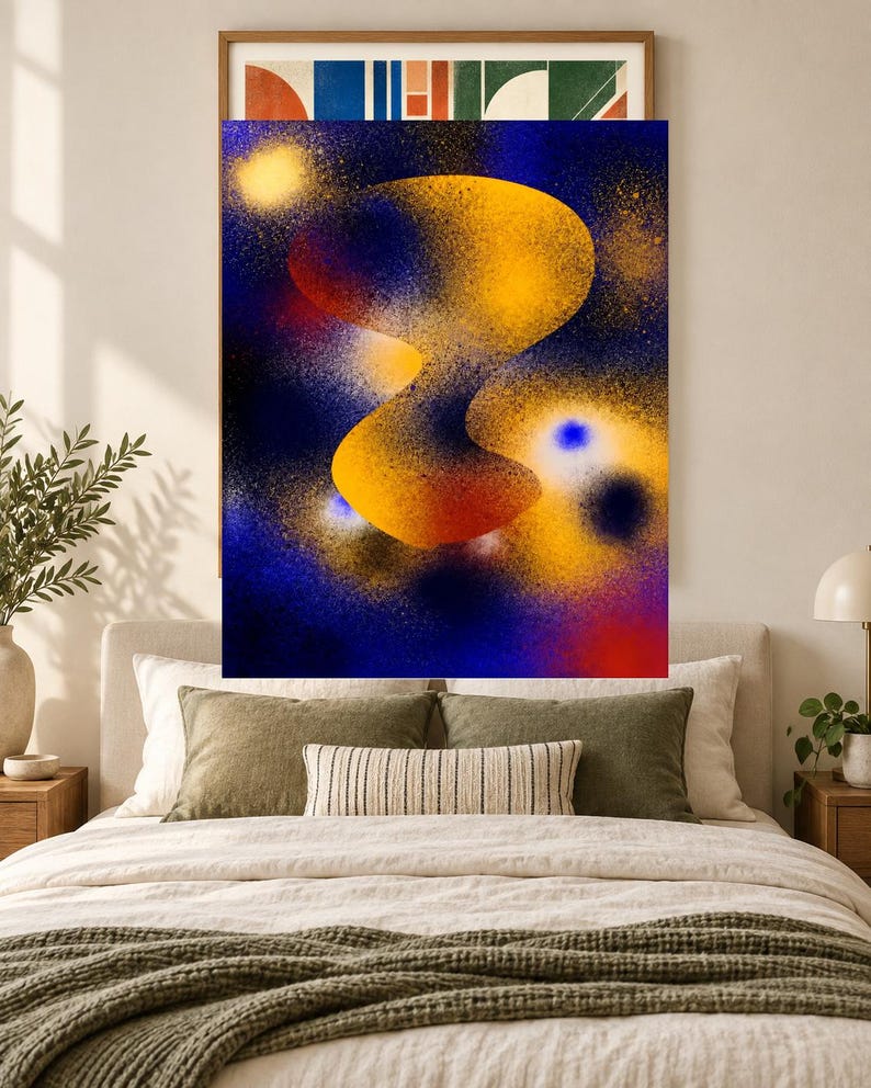May include: A rectangular wall art print featuring an abstract composition with a central, organic, golden-yellow shape set against a deep blue background. The design incorporates spray-painted textures, glowing yellow orbs, and subtle red accents.