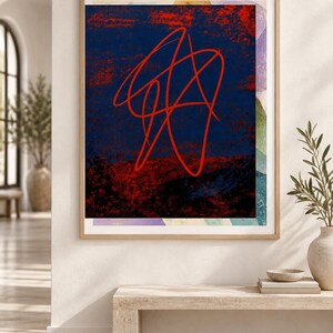 May include: A framed rectangular wall art piece featuring a dark blue and red textured background with a prominent, continuous red line drawing in the center. The artwork is enclosed in a light-toned wooden frame and displays abstract shapes.