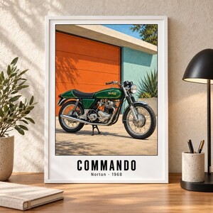 May include: A framed wall art print featuring a green Norton Commando motorcycle parked in front of an orange wall and a blue structure. The text at the bottom reads COMMANDO Norton 1968. The motorcycle has a black seat, chrome exhaust, and wire-spoke wheels.