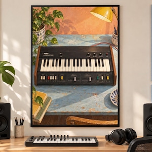 May include: A framed wall art print featuring a vintage Korg 700S synthesizer with black casing, white and black keys, and colorful control switches, set against a rustic blue wooden table with a yellow lamp and green potted plant.