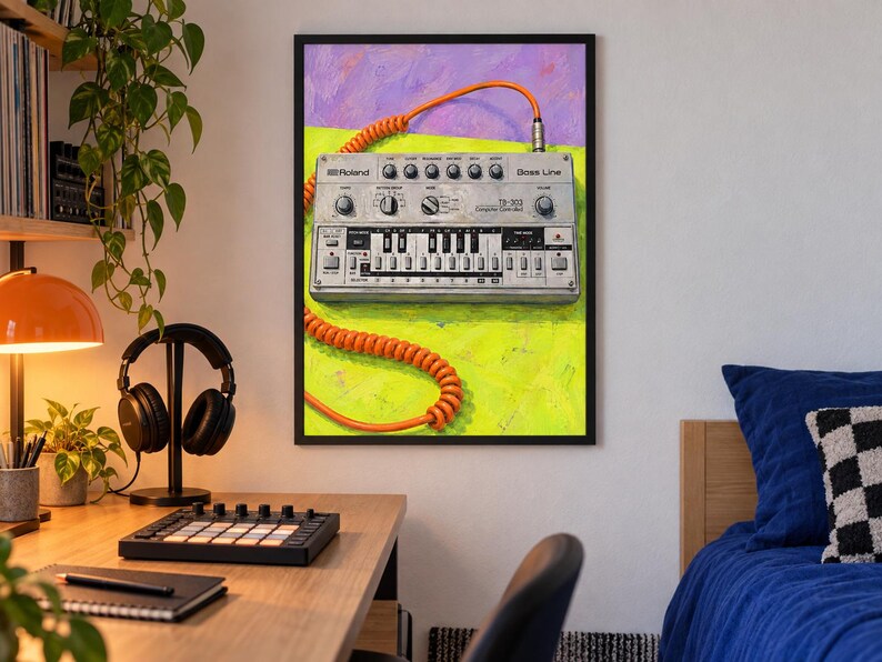 May include: A framed wall art print featuring a silver Roland TB-303 Bass Line synthesizer with a bright orange coiled cable. The synthesizer is set against a vibrant background of lime green and purple, showcasing its knobs, keys, and text.