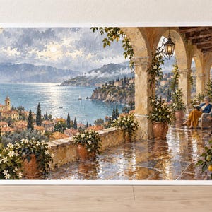 Puede incluir: Una pintura de paisaje que muestra una escena costera mediterr&aacute;nea desde una terraza de piedra con columnas arqueadas. La vista incluye un mar azul, un pueblo en la ladera con techos de terracota y una persona sentada leyendo bajo los arcos.