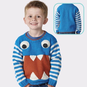 May include: A blue knitted sweater with white stripes on the sleeves and a monster face design on the front. The monster has large eyes, a toothy grin, and a brown mouth.