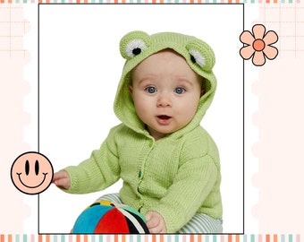 May include: A baby wearing a green knitted frog hooded sweater, sitting and holding a colorful ball.