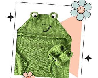 May include: A green knitted hooded towel with a frog face and two frog hand puppets. The frog face has black eyes, a black smile, and a black nose.