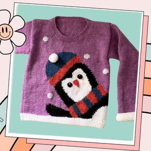 May include: A purple knitted jumper with a white penguin design. The penguin is wearing a red and blue hat and scarf. The jumper has white snowflakes on it.