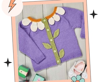 May include: A purple knitted cardigan with a white daisy flower design on the collar and a green stem with leaves down the front. The cardigan has button closures.