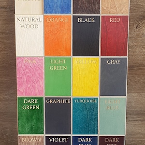 May include: A color palette chart with 18 different wood samples stained in various colors, including navy blue, dark brown, light brown, orange, black, red, pink, light green, yellow, gray, dark green, graphite, turquoise, light blue, brown, violet, dark blue, and dark red.