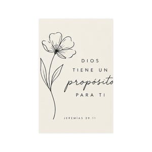 May include: A rectangular off-white card featuring a black line art drawing of a single flower on the left side. To the right, the text reads DIOS TIENE UN propósito PARA TI, followed by the smaller text JEREMÍAS 29:11 at the bottom center.