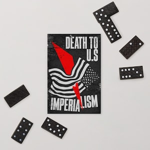 May include: A rectangular print featuring a black background with the white text DEATH TO U.S IMPERIALISM and a stylized graphic of a waving flag intersected by a sharp red lightning bolt shape, surrounded by five black dominoes with white dots.