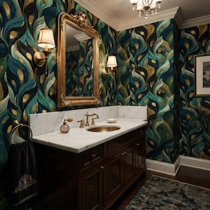 May include: A bathroom vanity with a white marble countertop, a brass sink, and a dark wood cabinet. Above the vanity is a gold-framed mirror flanked by two wall sconces. The walls feature wallpaper with a swirling teal, black, and gold pattern.