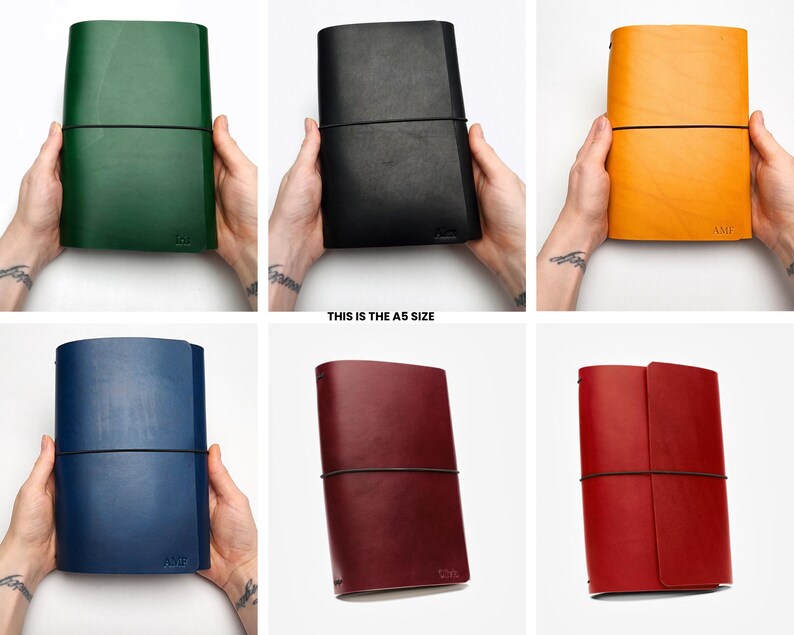 May include: A collection of A5 size leather journals in various colors: green, black, yellow, blue, burgundy, and red. Each journal is held open with a black elastic band. The text "THIS IS THE A5 SIZE" is visible.