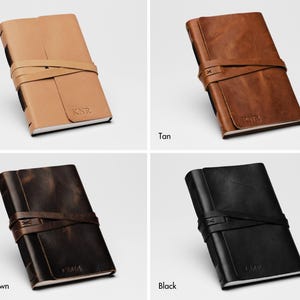 May include: Four leather-bound journals in different colors: natural, tan, dark brown, and black. Each journal has a leather strap closure and the initials "KNR" embossed on the cover.