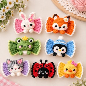 May include: Six crocheted hair bows featuring animal designs: a white rabbit, an orange fox, a green frog with a yellow crown, a blue penguin with a hat, a gray cat, a red ladybug, and a yellow chick, each with pink cheeks and white accents.