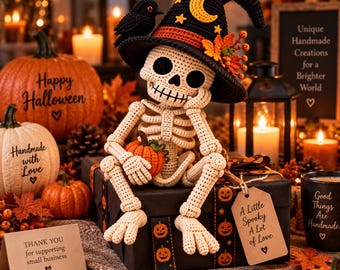 May include: A crocheted skeleton figure wearing a black witch hat with a yellow crescent moon and stars, holding a small orange pumpkin. The skeleton sits on a black gift box decorated with pumpkin patterns and a tag reading A Little Spooky A Lot of Love.