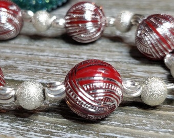 Elegant Silver and Red Beaded Wire Bracelet with a Decorative Silver Toggle Clasp Closure