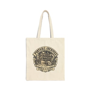 May include: A natural-colored canvas tote bag featuring a black graphic print. The design displays a stack of books, a candle, a quill, and a compass, with the text "PORTABLE ARCHIVES" and "FORGE & FABLE" along with "MAPS + BOOKS + JOURNALS + ADVENTURES".