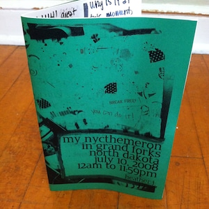 May include: A green flyer with black text announcing a music event called "my nycthemeron" in Grand Forks, North Dakota on July 10, 2008 from 12am to 11:59pm. The flyer has a black and white graphic design with the text "Break Free! You can do it!"