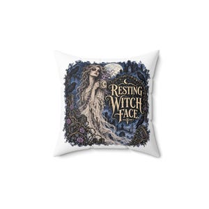 May include: A square white throw pillow featuring a graphic illustration of a woman holding a mug in a graveyard setting with ravens, thorny vines, and purple roses. The text reads, "RESTING WITCH FACE." The scene includes a full moon.