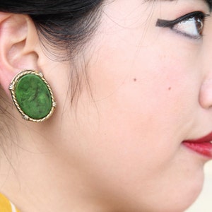 Green swirl, end of day, oval bakelite earrings with goldtone frame, clip ons, 1&quot; x 1 1/4&quot;