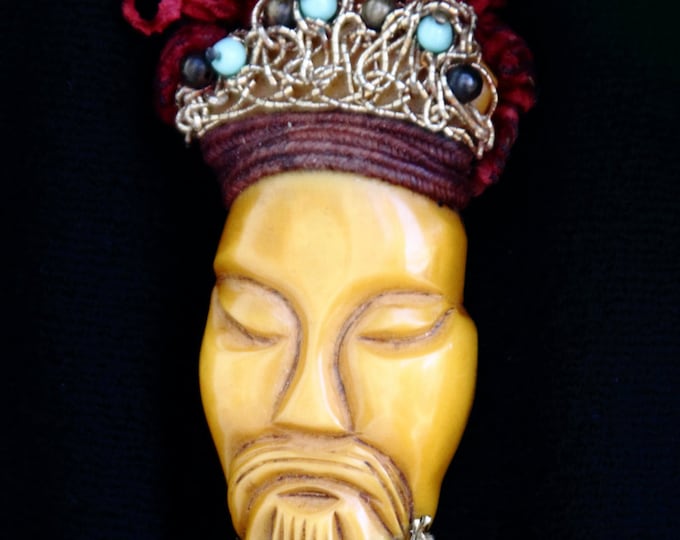 Carved, 1930s, resin washed butterscotch bakelite brooch of asian figure or man's face, with ornamentation Large 3 3/4 x 1  1/2