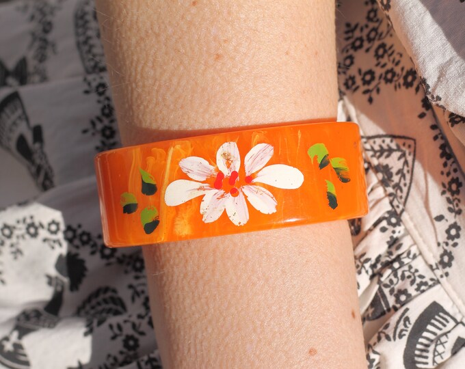 Virbrant tangerine swirl bakelite cuff bracelet with original hand painted floral design.