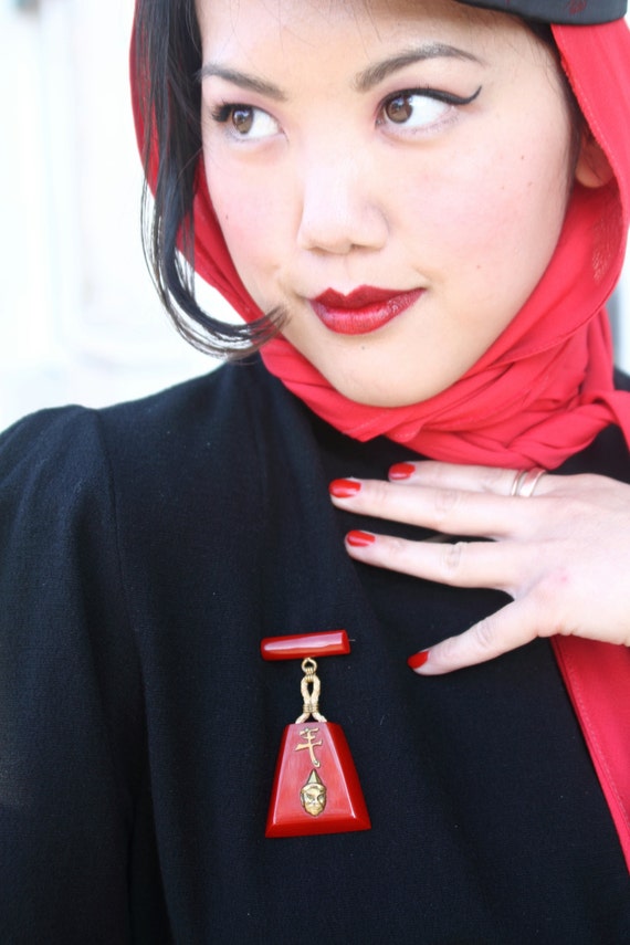 Large cherry red bakelite bar brooch, Asian themed