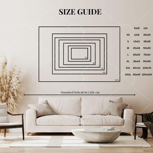 May include: A size guide chart for wall art featuring nested black rectangles labeled XS through XXXL. A table lists dimensions in inches and centimeters, ranging from 12x8 inches to 60x40 inches. A reference line indicates a standard sofa width of 90 inches.