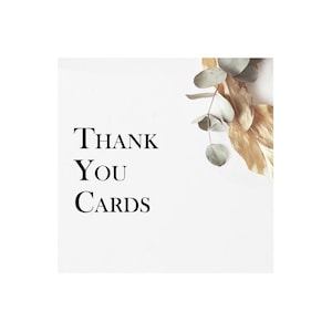 May include: White card with the text "THANK YOU CARDS" in black font. A sprig of eucalyptus with gold leaves is in the upper right corner.