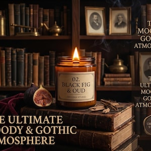 May include: A lit candle in a brown glass jar with a label reading 02. BLACK FIG & OUD OBSIDIAN STUDIO. The candle sits on a stack of old books next to a sliced fig and wood chips. The text THE MOODY & GOTHIC ATMOSPHERE appears on the image.