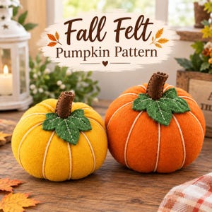 May include: Two handmade felt pumpkins, one yellow and one orange, each featuring a brown stem and green leaf detail with white stitching. The text "Fall Felt Pumpkin Pattern" is displayed above the pumpkins in a decorative script font.