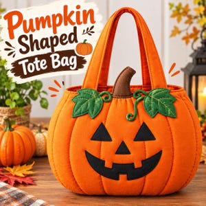 May include: An orange pumpkin-shaped tote bag featuring a black jack-o'-lantern face, green fabric leaves, and a brown stem. The bag has two orange handles and is labeled with the text Pumpkin Shaped Tote Bag in the upper left corner.