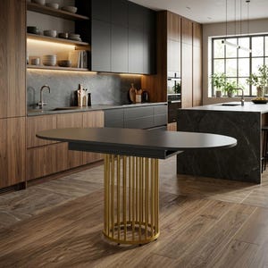 May include: An oval dining table with a matte black tabletop and a cylindrical base composed of vertical gold-toned metal rods. The table is positioned in a kitchen with wood cabinetry, dark stone countertops, and a large window with natural light.