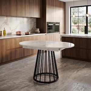 May include: An oval dining table featuring a white marble top with grey veining. The base consists of a series of vertical black metal rods arranged in a circular, cage-like structure that connects to a solid black circular floor ring base.