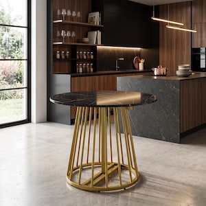 May include: A round table featuring a black marble top with white veining and a gold-colored metal base. The base is constructed from a series of vertical metal rods arranged in a conical shape, connected by a circular ring at the bottom.