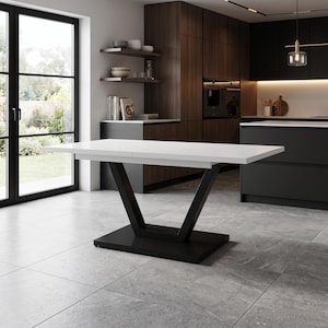 May include: A rectangular dining table featuring a smooth white tabletop surface supported by a black V-shaped pedestal base that connects to a flat, rectangular black floor plate, providing a stable foundation for the elevated white surface.