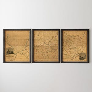 May include: Three framed wall art pieces featuring a vintage map of Kentucky in a triptych layout. Each print displays aged tan paper with dark brown ink lines showing geographical borders and topography, enclosed in simple black rectangular frames.