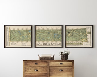 Puede incluir: Tres mapas vintage enmarcados de Golden Gate Park en San Francisco, California. Los mapas están en marcos negros y presentan una ilustración detallada del diseño del parque, incluyendo caminos, senderos y puntos de referencia. Los mapas se muestran en una pared sobre una cómoda de madera.